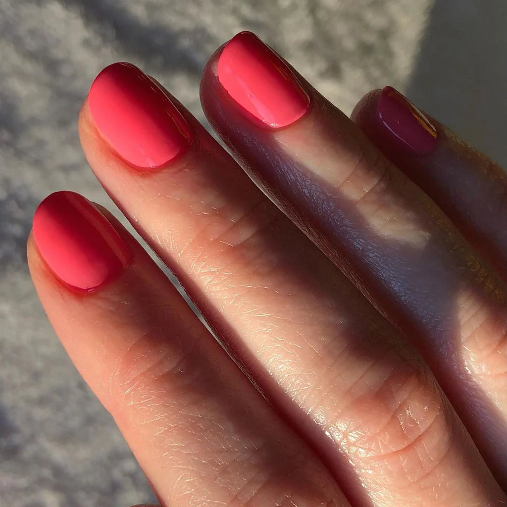 Hand wearing Bio Sculpture Gemini Nail Polish No. 250  Radiant Starfish – bold, vegan warm pink coral polish for inclusive, glowing manicures