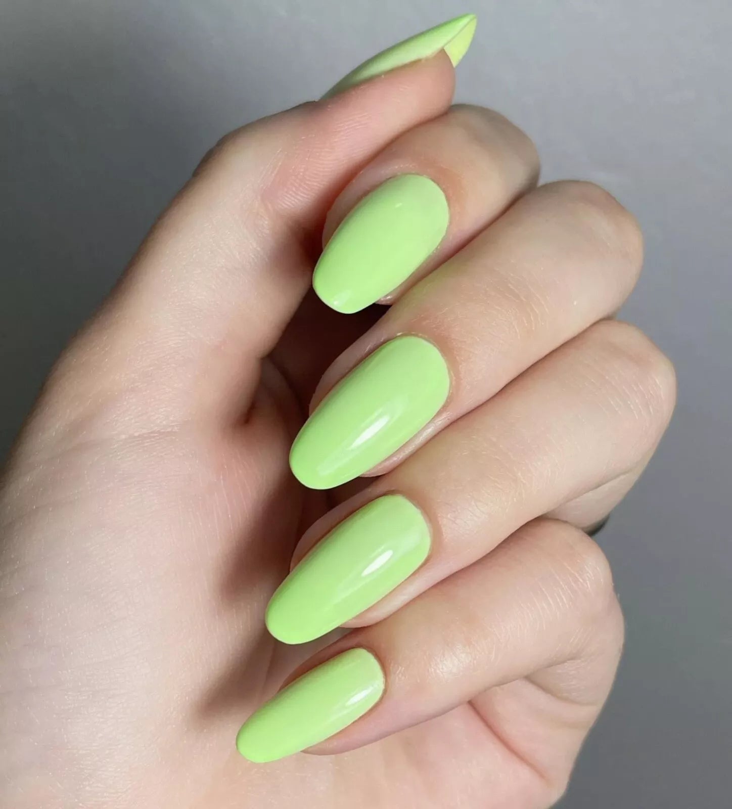 Bio Sculpture Gemini Nail Polish No. 300 Green Apple Smoothie 14ml. Close-up of Green Apple Smoothie polish on light skin – non-toxic, creamy pastel green shade for a chic, trendy nail look