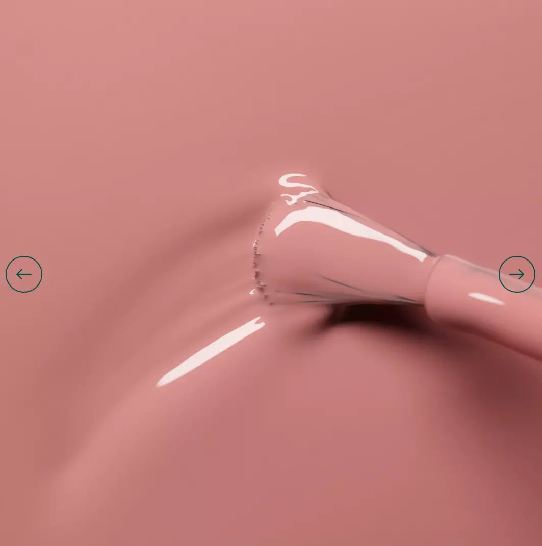 Polish brush dipped in Manucurist Old Rose nail polish – creamy, non-toxic muted rose pink formula for smooth application