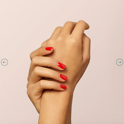 Fingers painted with Manucurist Poppy Red on light skin – non-toxic, intense red polish for modern style