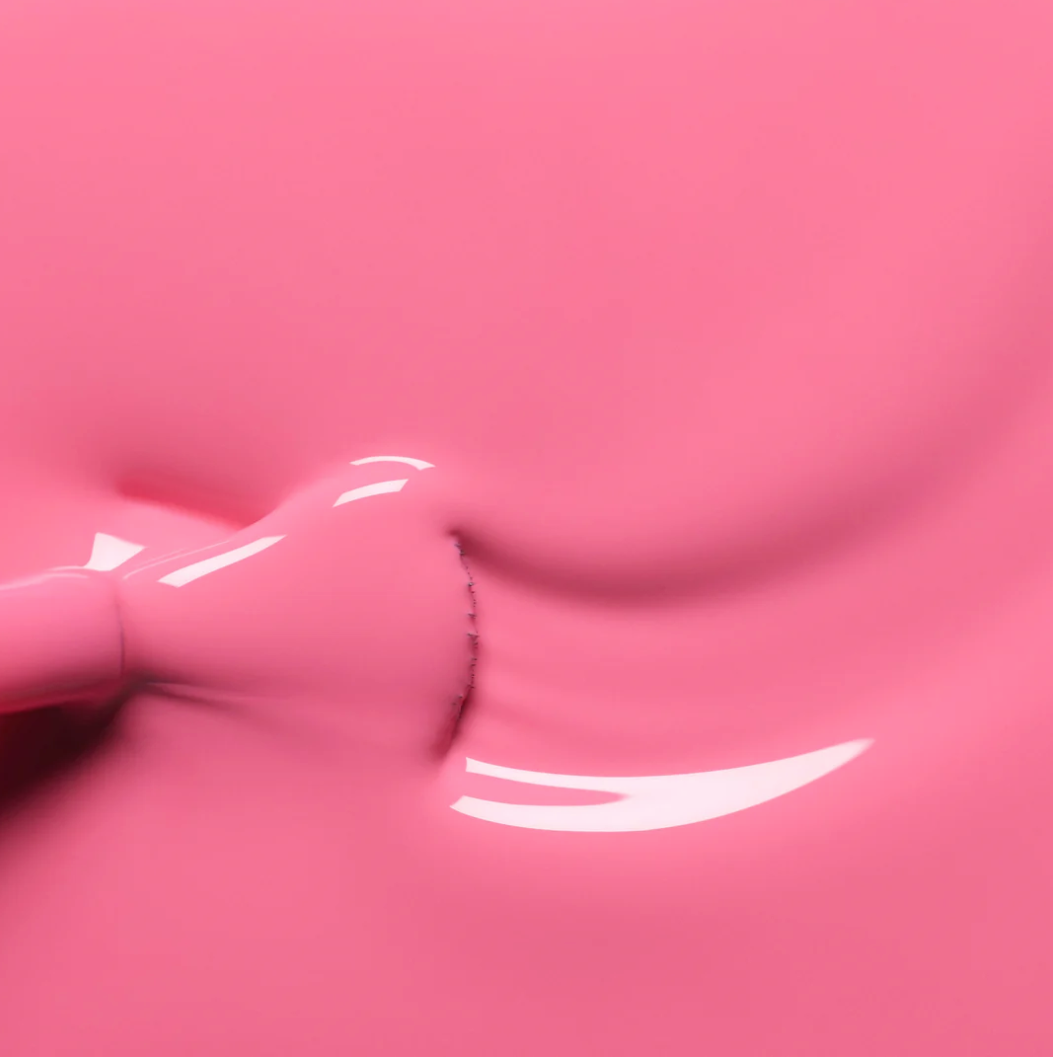Polish brush dipped in Manucurist Rose nail polish – creamy, non-toxic rose pink formula for smooth application