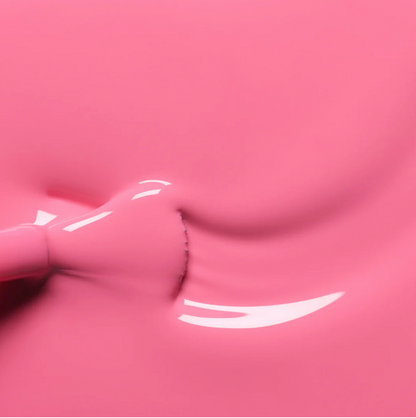 Polish brush dipped in Manucurist Rose nail polish – creamy, non-toxic rose pink formula for smooth application