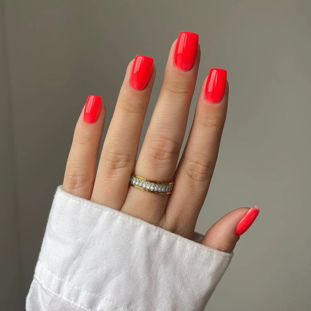 Hand wearing Bio Sculpture Gemini Nail Polish No. 104  Sweet Melon Fluo – bold, vegan fluorescent bright orange polish for inclusive, striking manicures